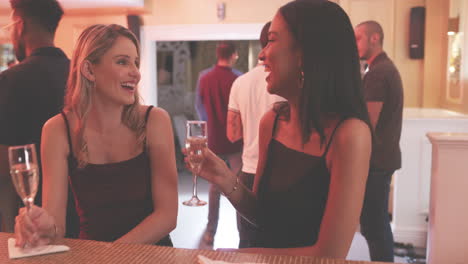 two young women toasting with their drinks