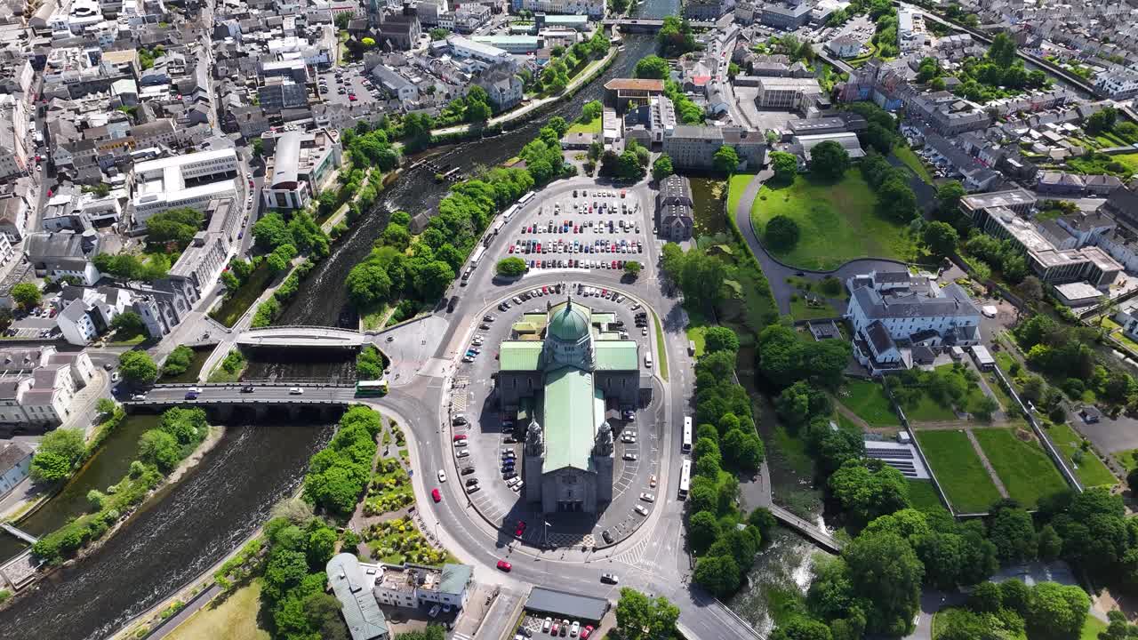 Beautiful aerial reveal of Galway Cathedral architecture from above to cityscape on coast.