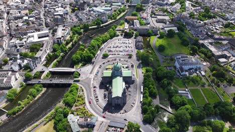 beautiful aerial reveal of galway cathedral architecture from above to cityscape on coast.