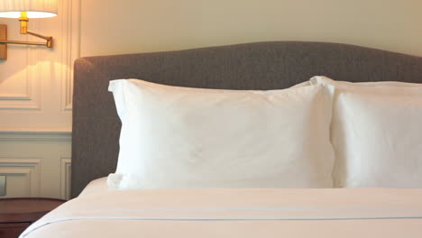 White-Cushions-on-Bed-with-Fresh-Clean-Sheets,-Left-Pan,-Interior