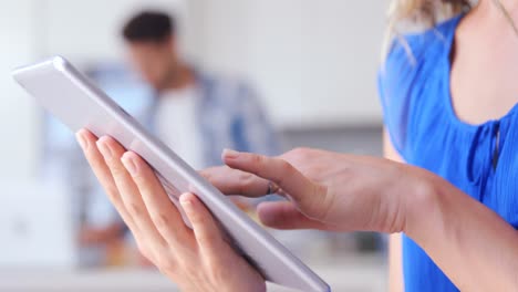 smiling woman using digital tablet