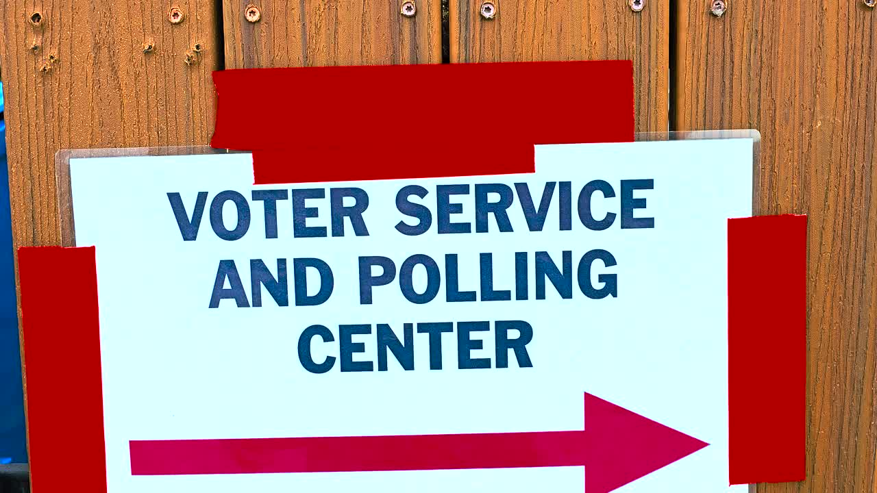 Outdoor video of a “Voting Service Polling Center” sign with an arrow pointing right, highlighting democratic values, voter accessibility, and participation in official election day processes