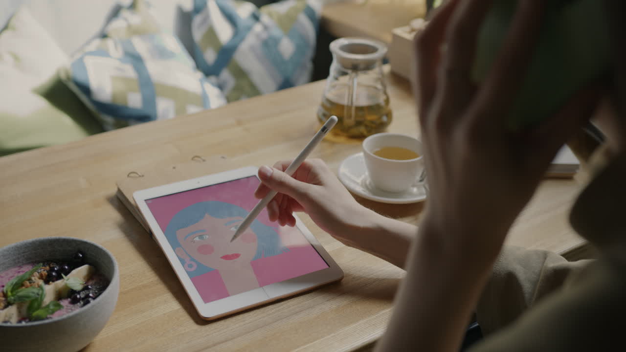 Woman working on digital art in a coffee shop