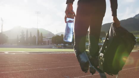 disabled mixed race man with prosthetic legs walking on a race track