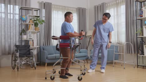 full body side view of asian male nurse making beckon hand gesture and encouraging a patient dispirited to walk by walker during a physical therapy at home