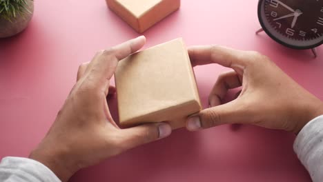 hands opening a cardboard gift box