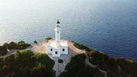 sunset at lighthouse in doukato lefkada greece, aerial reveal, panning