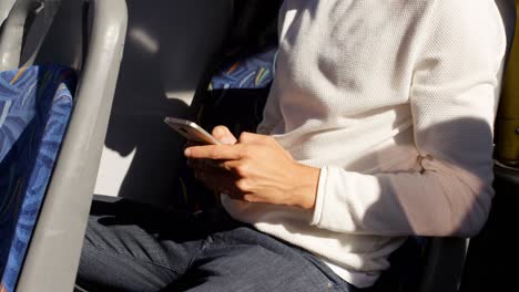 male commuter using mobile phone while travelling in bus 4k