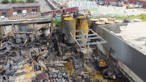 aerial view of the aftermath of a major fire at a petrochemical plant, catastrophic damage