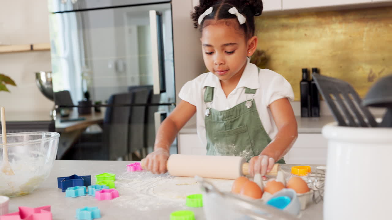 Happy girl kids baking cookies with rolling pin