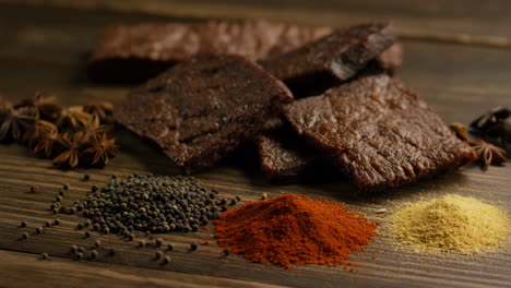 dried meat and spices on a wooden surface