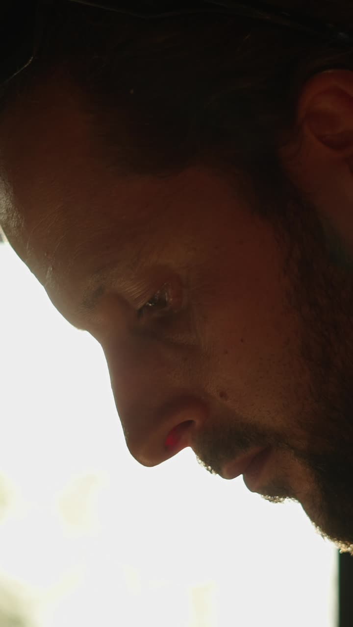 Close-up portrait of a man with beard in sunlight