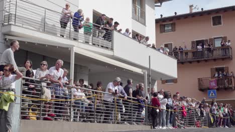 audience lining the street at the annual grape festival, verla di giovo, trentino, italy
