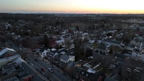 Traffic-on-main-street-of-american-town-at-sunset-time