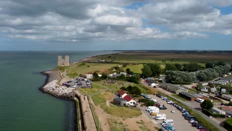 a high and wide drone shot of the stunning historical reculver towers in kent, england