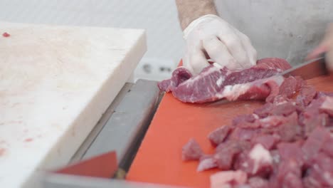 butcher cutting and preparing beef