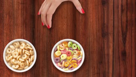 ofreciendo cuencos con anillos de cereales para el desayuno con leche