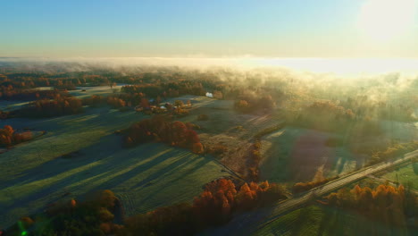 aerial drone shot of white cloud movement over beautiful green rural grasslands on a sunny day during morning time