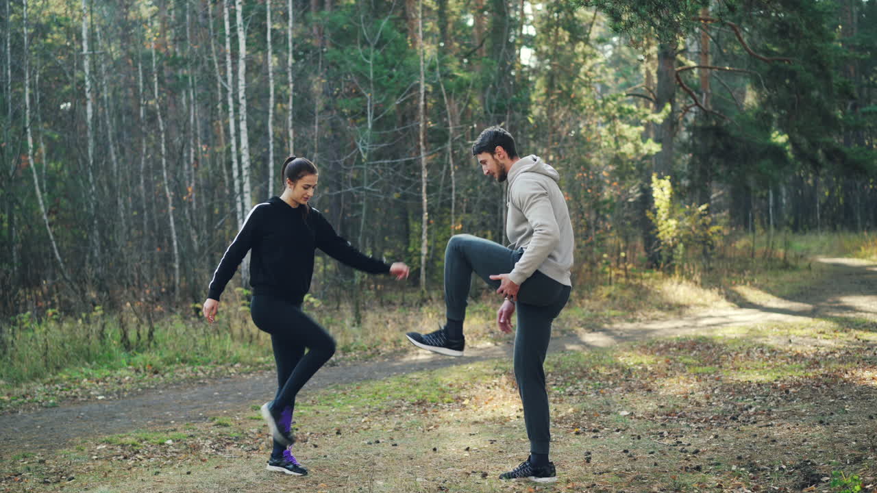 Couple exercising outdoors in the forest
