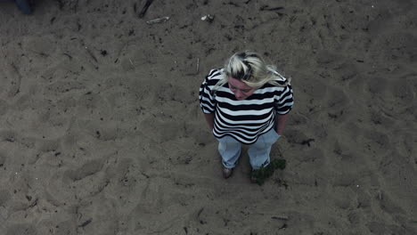 A-sad-lady-standing-in-solitude-in-the-wilderness-with-a-pensive-mood