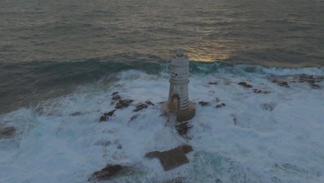 Mangiabarche-Lighthouse,-Sardinia:-Fantastic-aerial-view-travelling-in-the-beautiful-lighthouse-and-with-the-waves-hitting-the-rocks