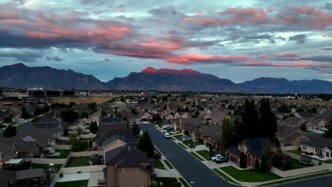 Suburban-community-in-the-shadow-of-the-Rocky-Mountains-at-sunset---rising-aerial-reveal