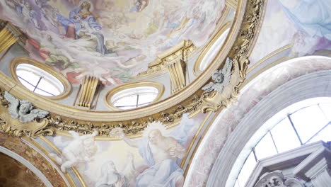 panning past beautiful ceiling artwork inside roman church