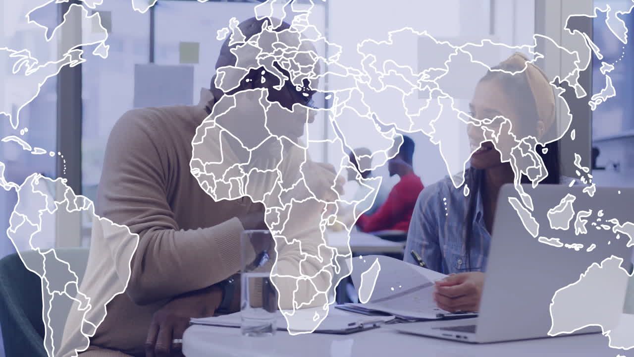World map animation over diverse colleagues discussing work at office desk
