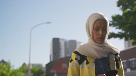 young woman wearing hijab out and about in the city