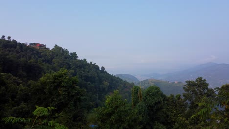 Dynamic-aerial-flying-over-forest-overlooking-Nepal-Landscape