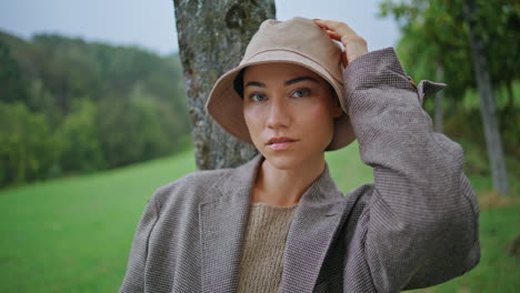 woman in a rain hat and jacket in a field