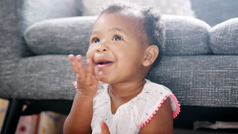 cute baby girl playing peek a boo at home