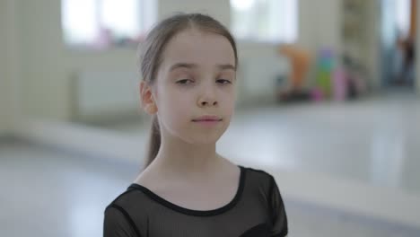 young ballerina practicing dance moves in studio