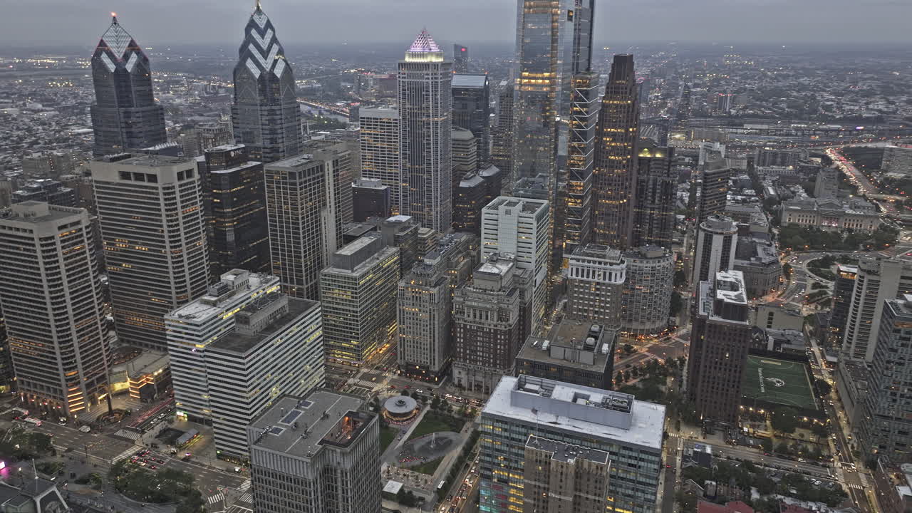 Philadelphia Pennsylvania Aerial v180 flyover center city capturing downtown cityscape under gloomy overcast sky at dusk, birds eye view of city hall - Shot with Mavic 3 Pro Cine - Sept 28th 2023