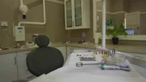 Empty-interior-of-dental-clinic-with-black-dental-chair-and-tools