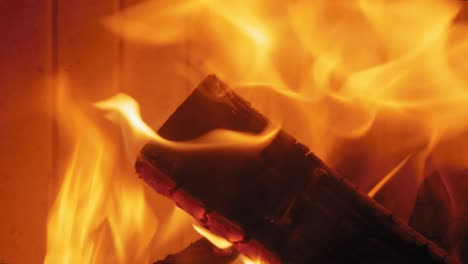 burning flame at fireplace on wooden logs