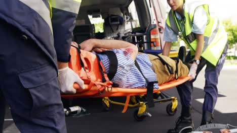 emergency medical technicians holding a wounded person