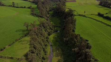 Slow-aerial-landscape-shot-of-the-San-Pedro-river-bed,-Machachi,-Ecuador