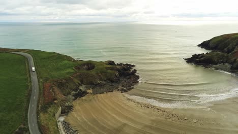 The-Copper-Coast-Road-Waterford-Ireland,-Kilmurrin-Cove-with-its-sheltered-bay-and-blowhole-a-popular-spot-for-swimmers