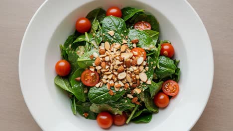 a fresh and nutritious spinach salad with cherry tomatoes and crunchy almonds perfect for healthy eating and meal prep