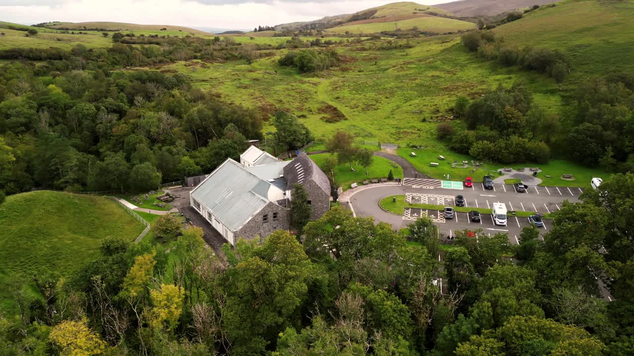 Wide rotating 4K 30FPS aerial of Marble Arch Caves in County Fermanagh, Northern Ireland on a bright sunny day. Produced with Rec709 color