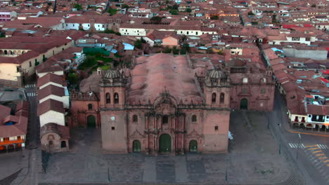 dolly in tilt up aerial over the cusco cathedral facade reveals the san blas neighborhood