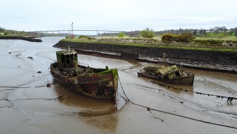 Stranded-old-boat-wreckage-off-the-river-Clyde-at-Bowling-harbour-in-Scotland