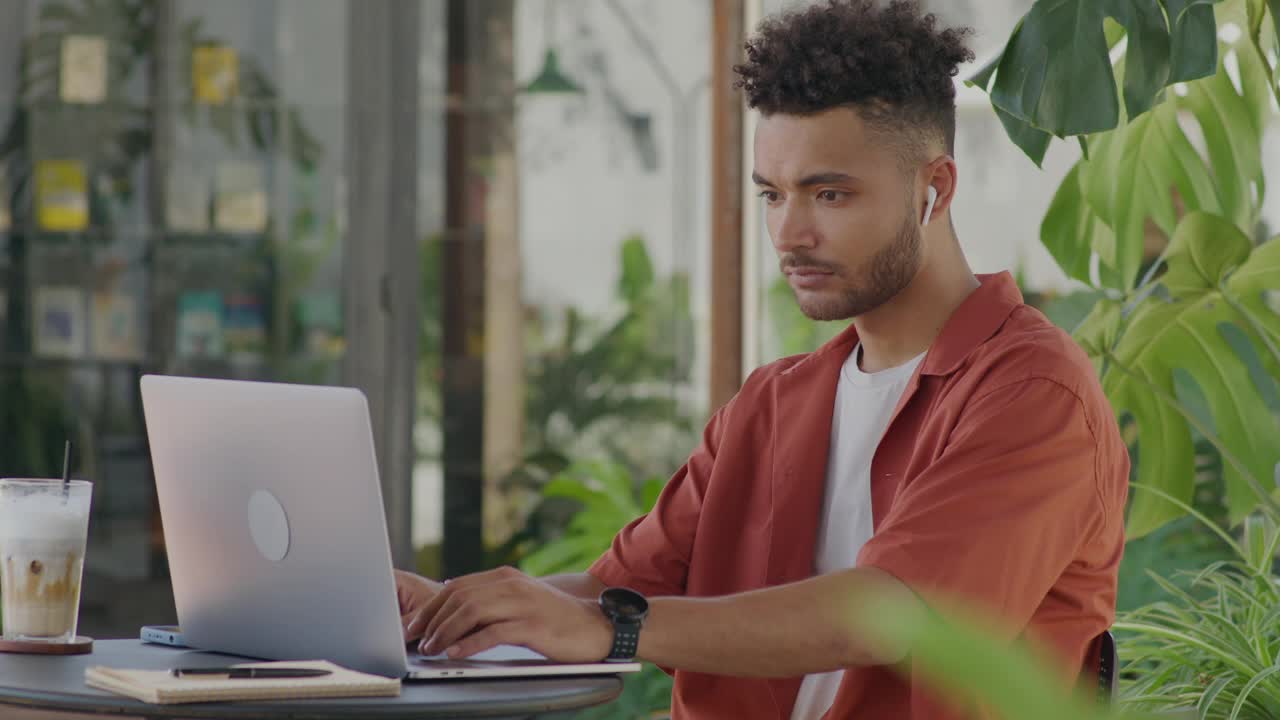 Freelancer Working on Laptop in Outdoor Coffeeshop
