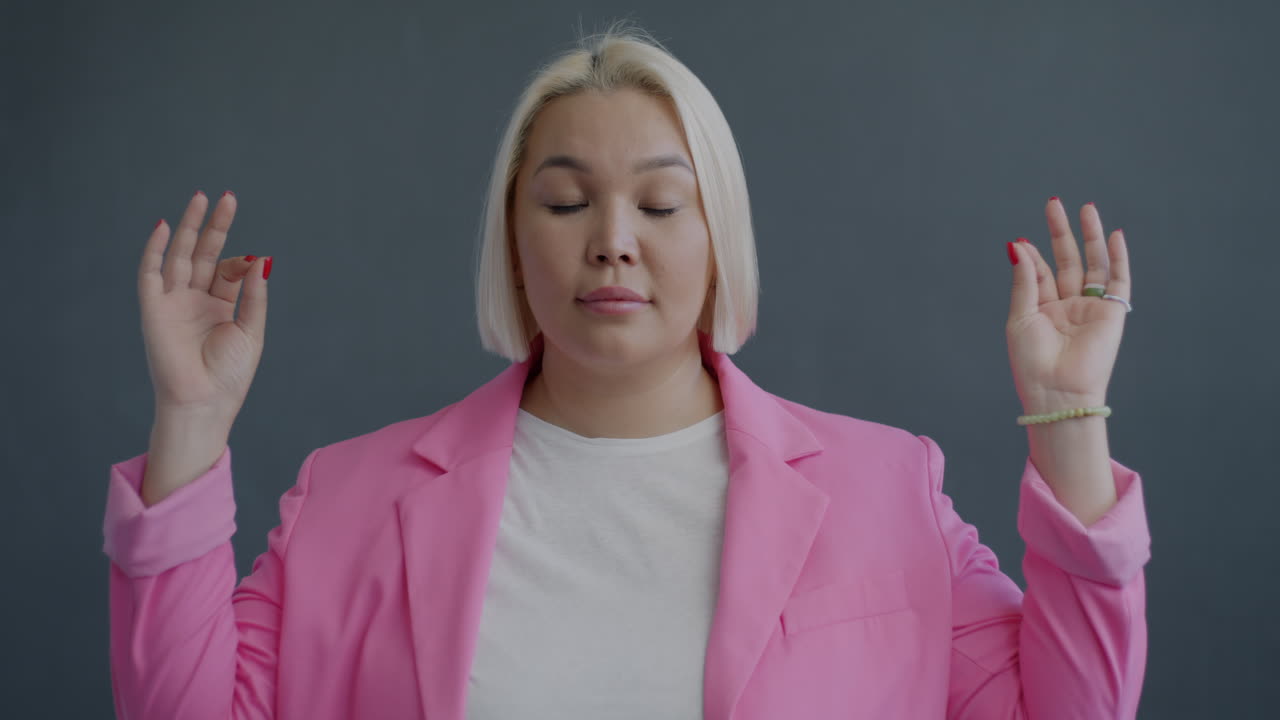 Woman Meditating in Pink Blazer
