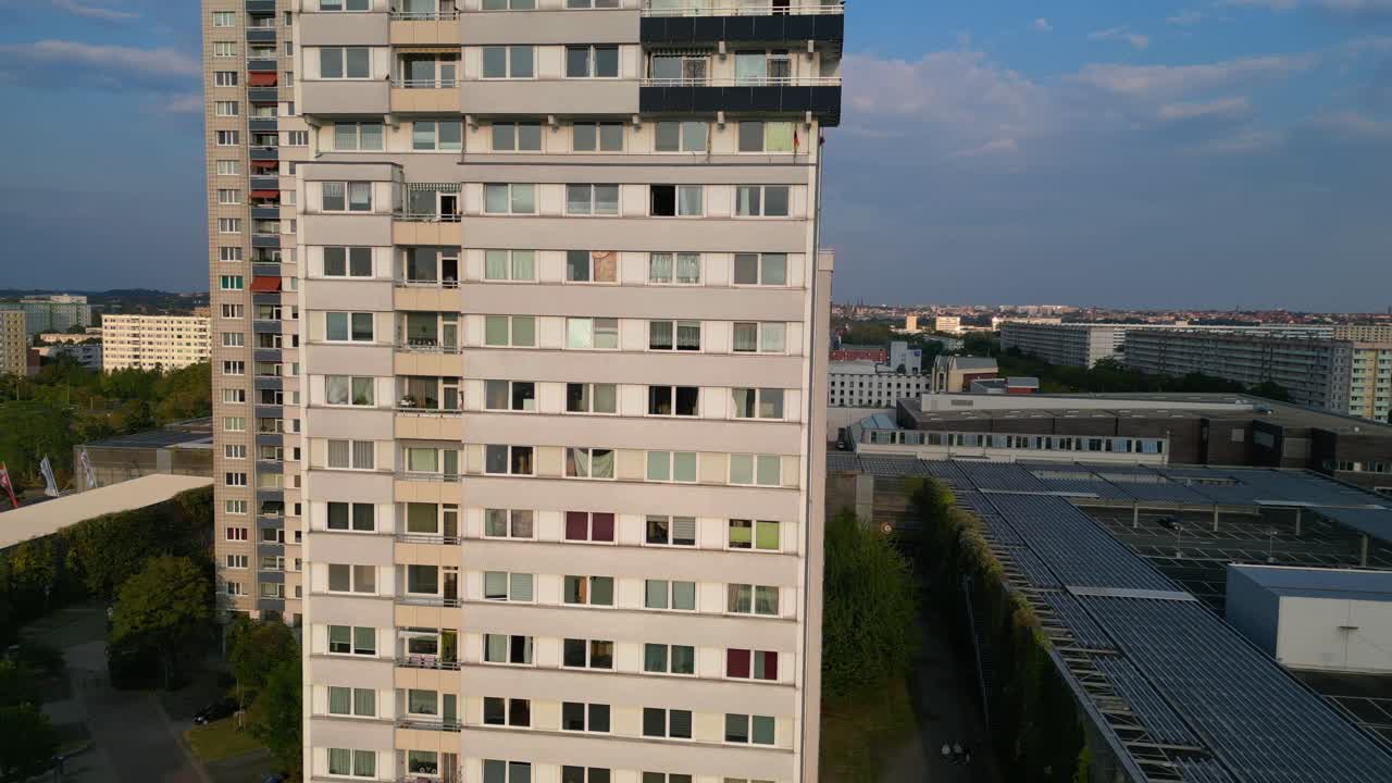 halle neustadt, a district of halle saale in germany, showing the typical plattenbau buildings at sunset. Gorgeous aerial view flight dolly left drone