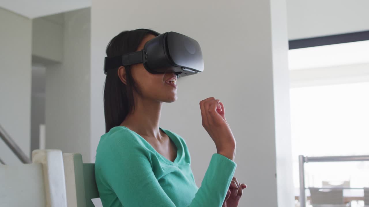African american woman using vr headset while working from home