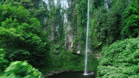 beautiful high katibawasan falls among the dense jungle in camiguin in the philippines on a cloudy day