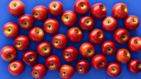 Red Apples Arranged on a Blue Background
