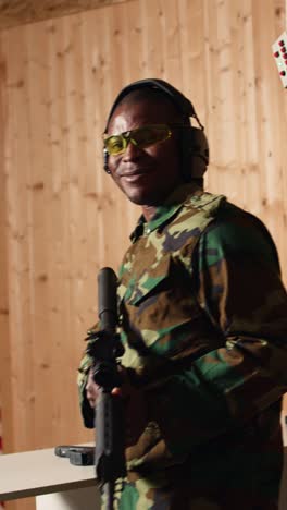 vertical video portrait of happy military personnel shooting assault rifle